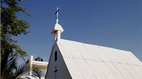 The Parish of Santisimo Sacramento is always bustling. A steady stream of parishioners can be seen kneeling in pray most every hour of the day. Bottom, is a motor taxi, one of the more common forms of transportation.